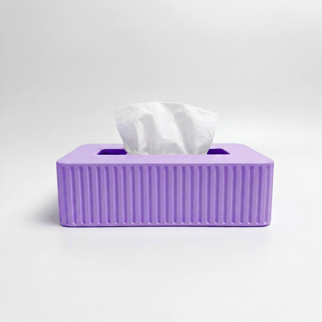 A purple rectangular tissue box cover with vertical fluted ridges on the front, holding a white tissue paper, set against a plain light gray background.