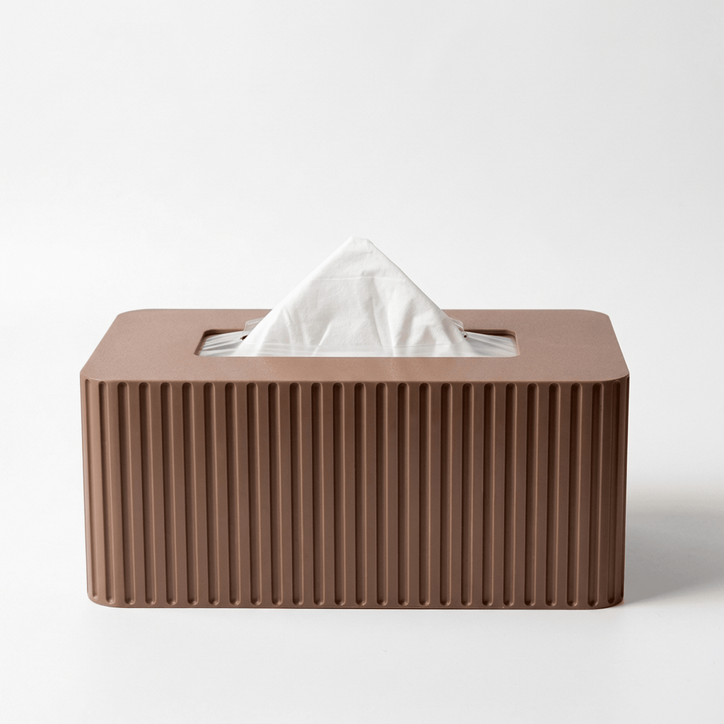 Black fluted standard Kleenex box cover on a desk
